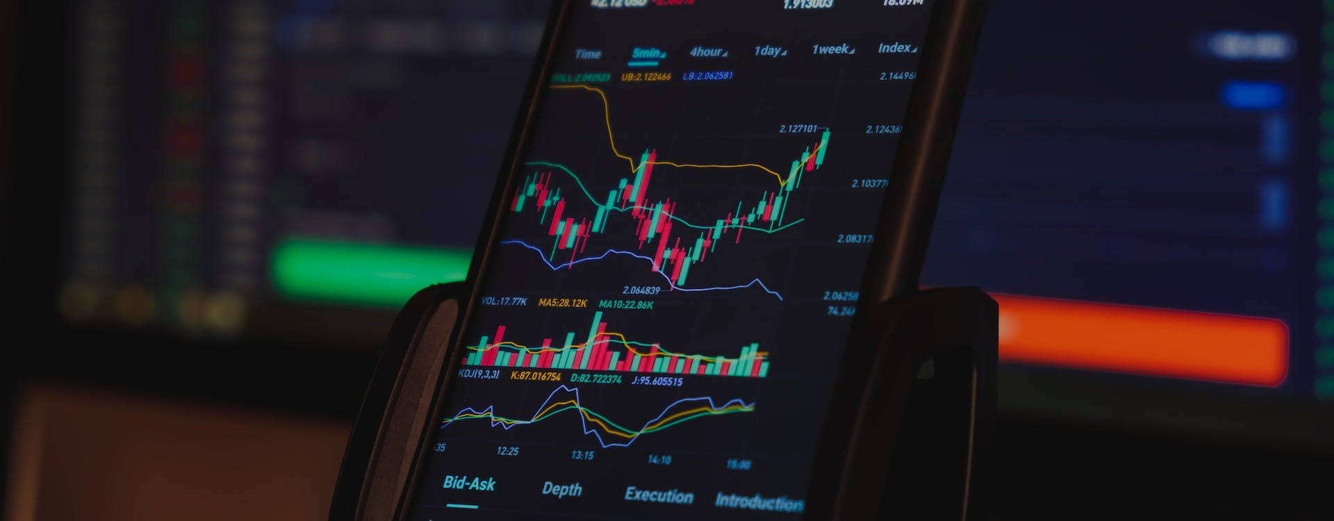 phone with trading charts